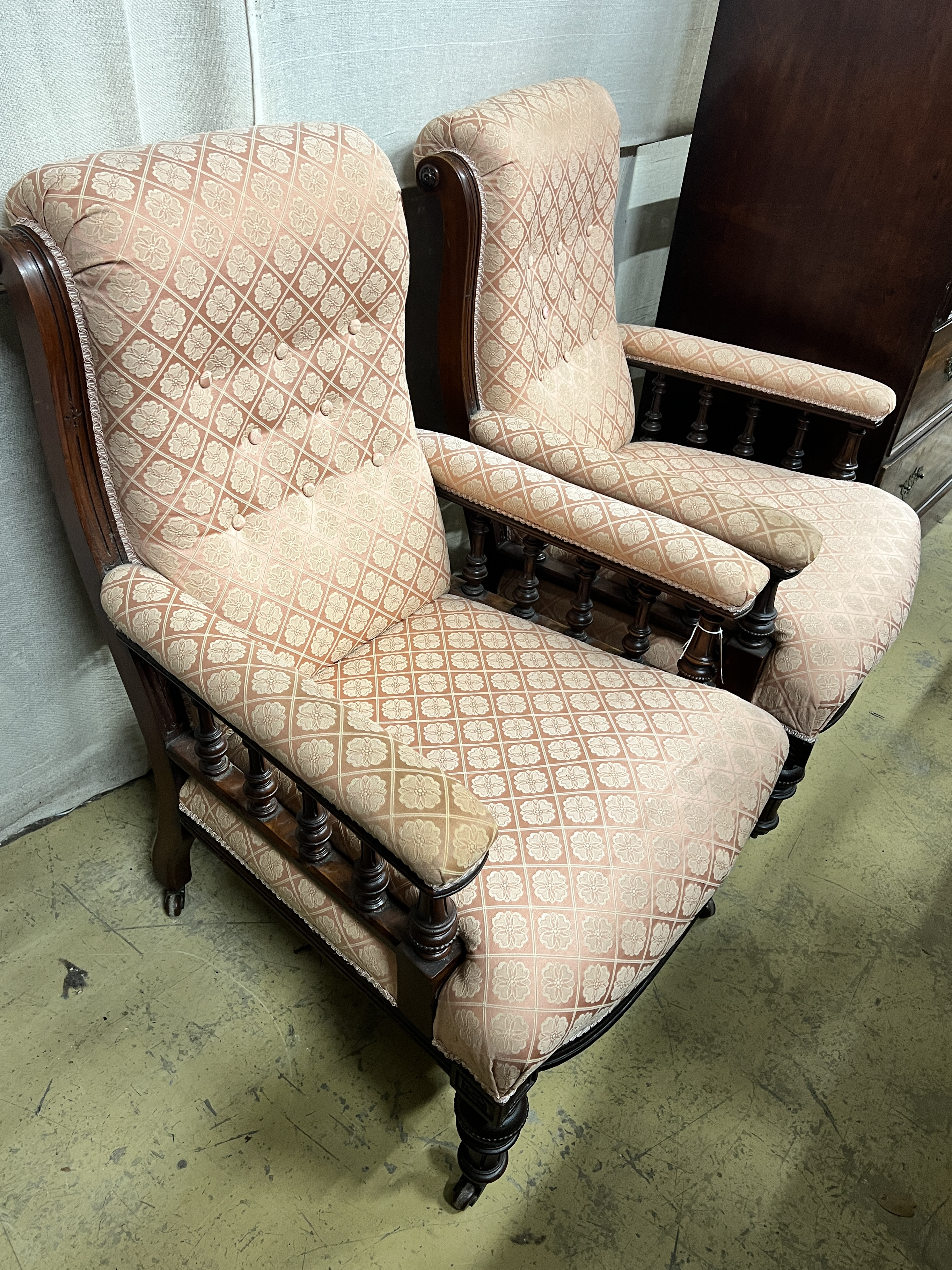 A pair of late Victorian upholstered walnut library chairs, width 68cm, depth 78cm, height 100cm